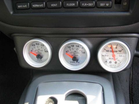 2003 Mercury Marauder - Close-up of a car's interior showing oil pressure, voltage, and boost gauges installed on the dashboard.