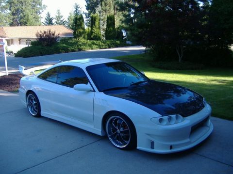 1995 Ford Probe - Modified 1995 Ford Probe with custom body kit and black hood sits in a driveway.