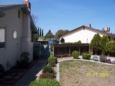 1991 Ford Bronco - A residential backyard scene captured on July 1, 2005, showing a house and landscaping.