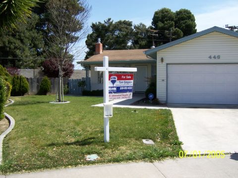 1991 Ford Bronco - A suburban house is listed for sale with a real estate sign in the front yard.