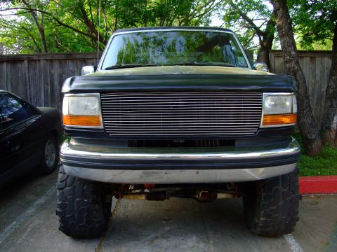 1992 Ford Bronco - This 1992 Ford Bronco features a prominent chrome grille and an elevated suspension system.