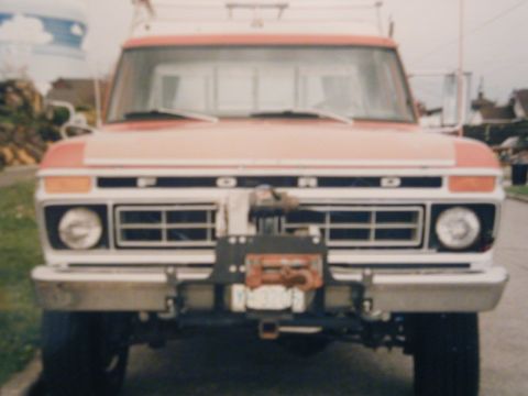 1977 Ford F-150 - This Ford truck features a prominent winch assembly on its front bumper, with the brand name clearly visible on the grille.