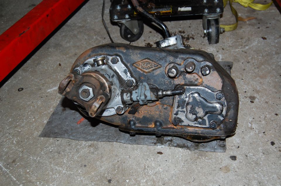 transfer case with a diamond-shaped logo on it, sitting on a mat on the floor