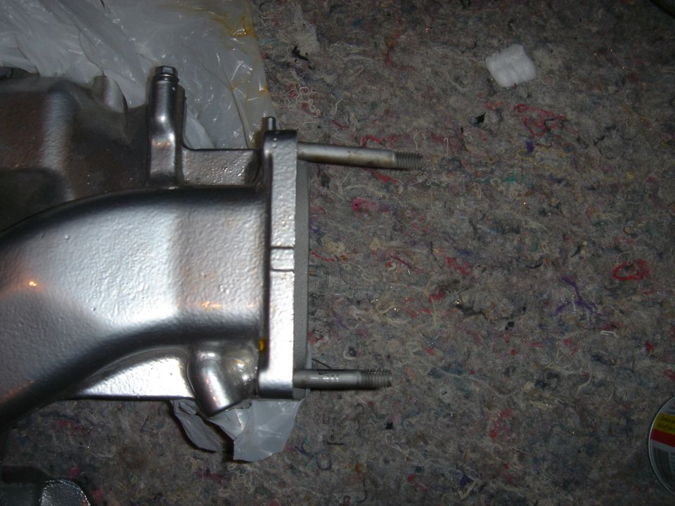 Refinished cast intake manifold component on a fabric surface