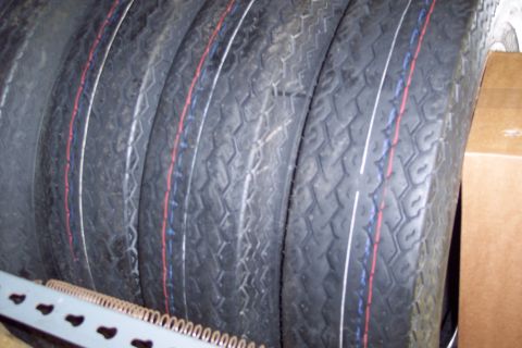 2001 Ford Crown Victoria - Four tires are stacked together, showing their tread patterns and colored sidewall stripes.