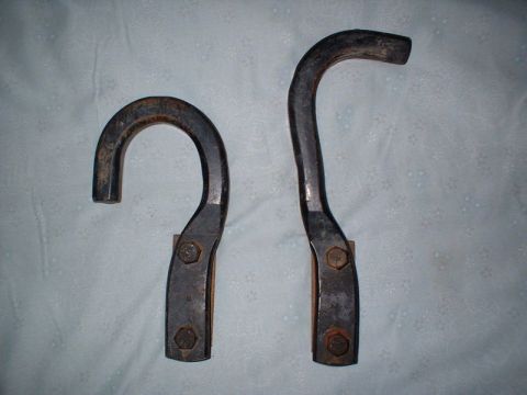 2000 Chevrolet Tahoe - Two metal hooks, one curved and one more angular, are shown against a textured background.