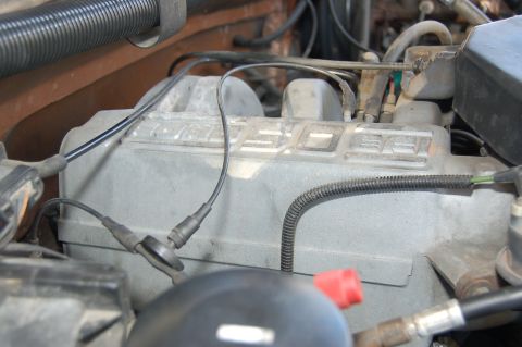 1989 Ford Bronco - The engine's valve cover clearly shows the word 'DIESEL' embossed on its surface.