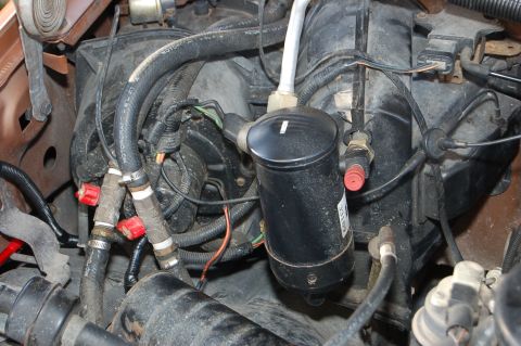 1989 Ford Bronco - Close-up view of various engine components, including hoses and wiring.