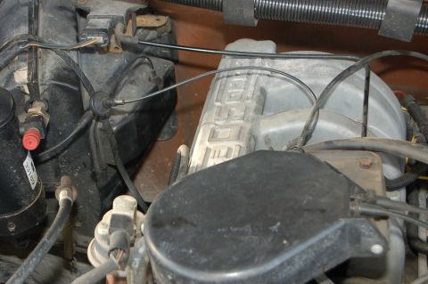 1989 Ford Bronco - Close-up of an engine intake manifold with 'FORD' embossed on its side.
