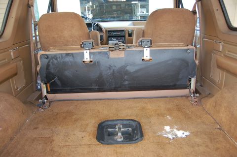 1989 Ford Bronco - The interior of a 1989 Ford Bronco, viewed from the rear cargo area towards the front seats.