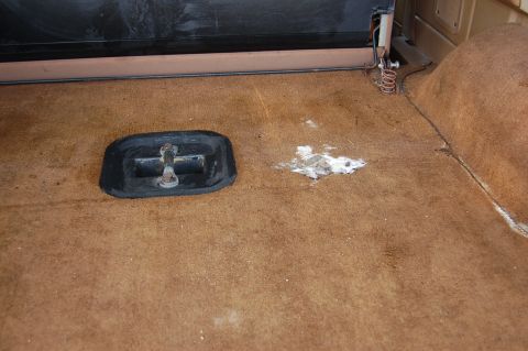 1989 Ford Bronco - The cargo area floor shows a tie-down anchor and some white residue.