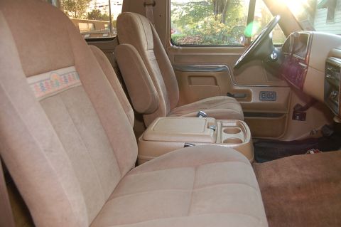 1989 Ford Bronco - Interior view of a 1989 Ford Bronco, tan upholstery and a center console.