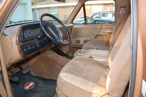 1989 Ford Bronco - Interior view of a 1989 Ford Bronco, its tan upholstery and dashboard details.