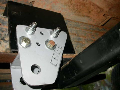 1990 Ford Bronco - Bolted in place. The upper bolts go all the way through and have a spacer in between the box and the frame. The lower bolts are just bolted…