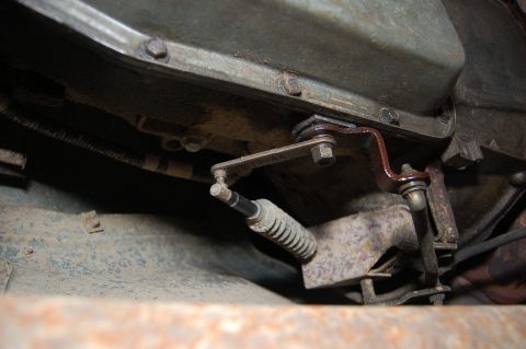 1989 Ford Bronco - Close-up view of a vehicle's transmission linkage system.