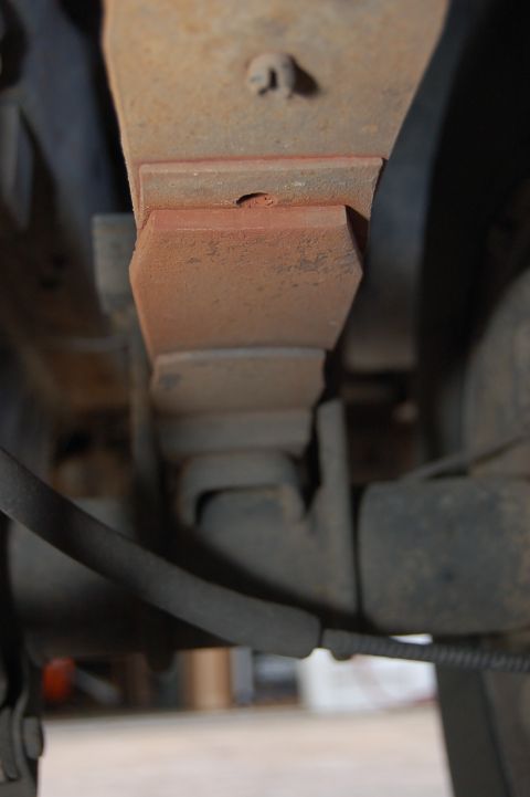 1989 Ford Bronco - Close-up of vehicle suspension components, showing rust and wear.