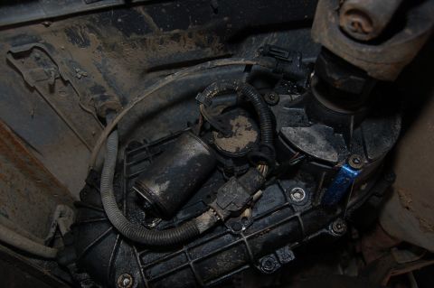 1989 Ford Bronco - Underside view of a vehicle's transfer case and driveshaft assembly.