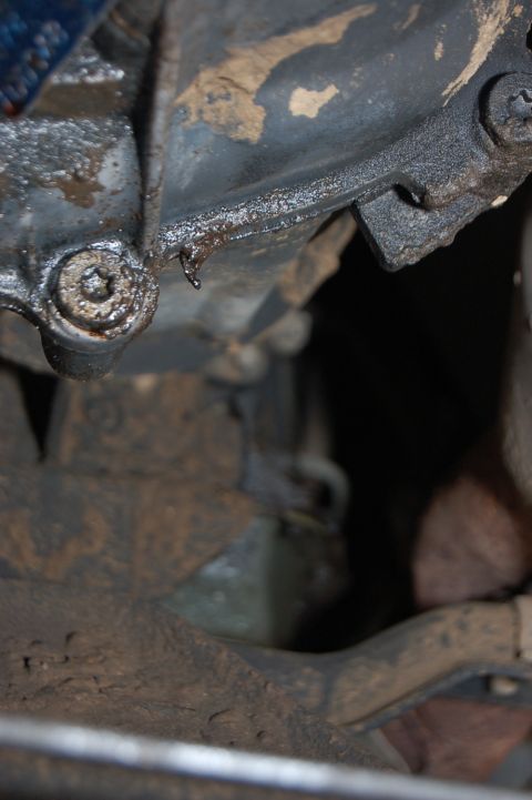 1989 Ford Bronco - Close-up view of a greasy underside component with visible oil dripping, suggesting a leak.