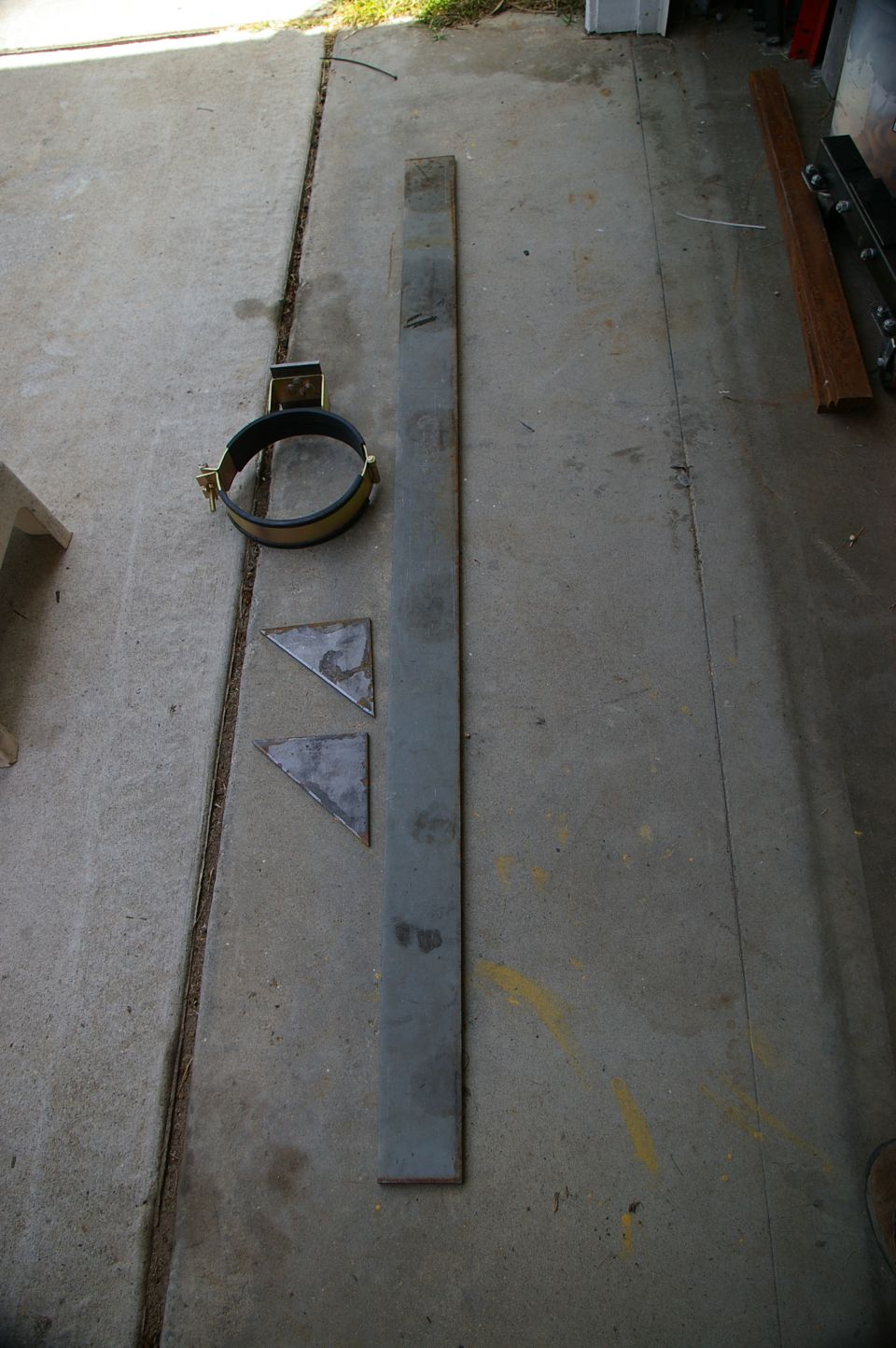 Tank rack clamp and metal pieces on concrete
