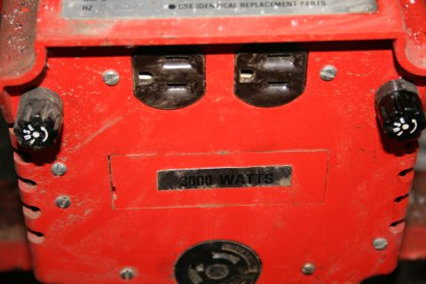 2003 Jeep TJ - Close-up of a red power generator, showing its outlets and power rating.