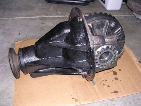 1983 Ferrari Enzo - Differential housing shown on cardboard with oil stains on the concrete floor.
