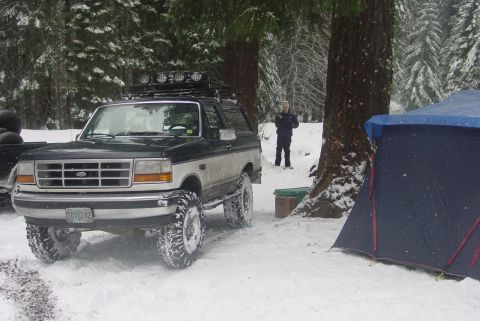 1993 Ford Bronco - 1993 Ford Bronco in snowy woods, equipped for off-road with a roof rack and lifted suspension.