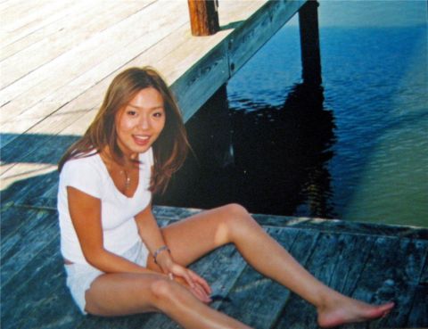 1993 Ford Probe - A woman poses for a photo while sitting on a wooden pier by the water.