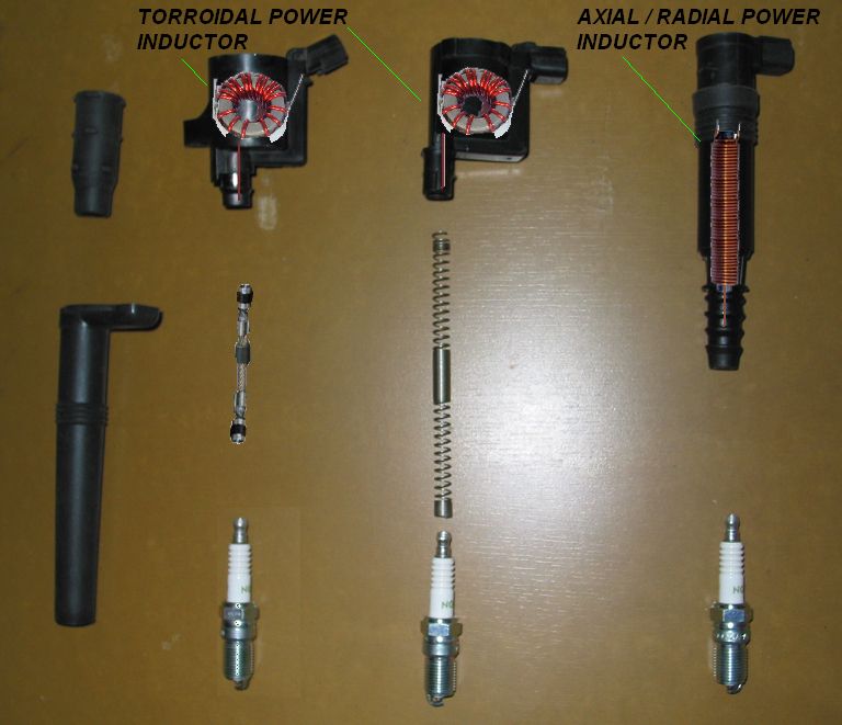 Two toroidal power inductors, one axial/radial power inductor, two spark plugs, two spark plug boots, and two springs laid out on a brown surface
