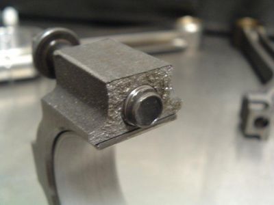2007 Ford Mustang - Close-up of a metal mechanical part with a bolt, likely from an engine or machinery.