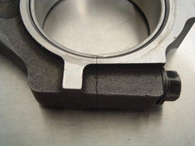 2007 Ford Mustang - A close-up view of a cracked connecting rod, showing a fracture originating near the bolt head.