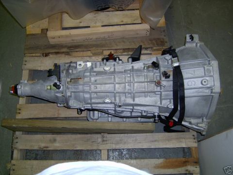2007 Ford Mustang - An automatic transmission is shown resting on wooden pallets.