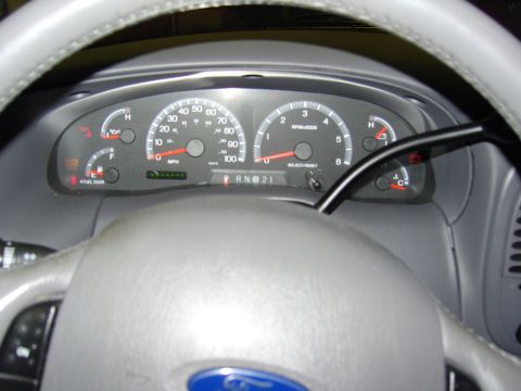 2007 Ford Mustang - Interior view of a vehicle's dashboard, showing the instrument cluster and steering wheel.