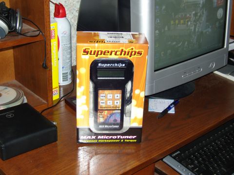 2007 Ford Mustang - Photo of a boxed Superchips Max MicroTuner handheld engine programmer advertised to increase horsepower and torque, sitting on a desk near…