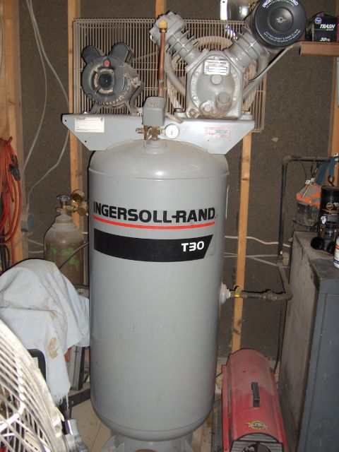 2007 Ford Mustang - An industrial air compressor is shown in a workshop setting.