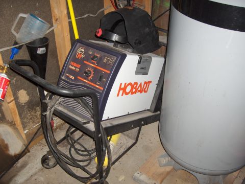 2007 Ford Mustang - A Hobart Handler 175 welder is shown with a welding helmet resting on its casing.