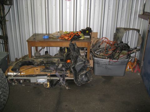 1994 Jeep YJ - Various vehicle components are organized and stored in a workshop or garage setting.