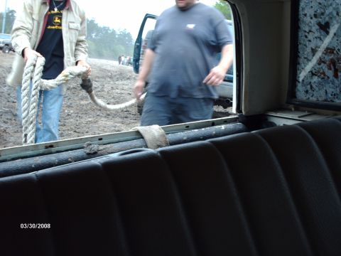 1982 Ford F-100 - People are gathered in a muddy area with a truck, possibly preparing for or recovering from an off-road activity.