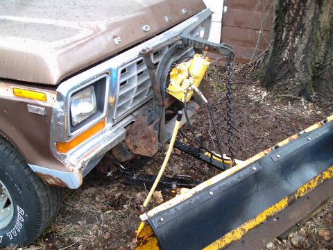 1978 Ford F-250 - Front view of a brown Ford truck equipped with a snow plow, exhibiting signs of age and use.