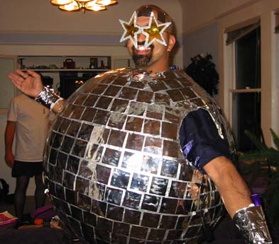 1989 Ford Bronco - A person wears a large disco ball costume complete with star-shaped glasses.