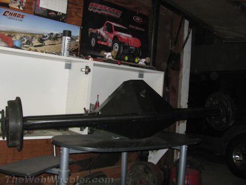 1968 Ford Mustang - A black rear axle assembly is displayed on a table in a garage setting.
