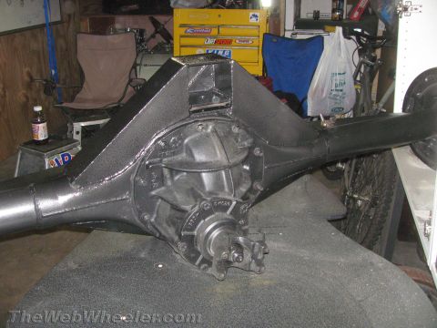 1968 Ford Mustang - A black rear axle assembly with a textured housing is shown in a workshop setting.