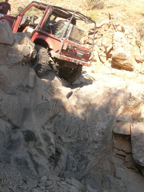 1974 Ford F-250 - Off-road vehicle navigates a challenging rocky terrain during an outdoor excursion.