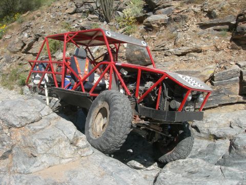 1974 Ford F-250 - This custom off-road buggy navigates a rocky trail in a dry, arid environment.