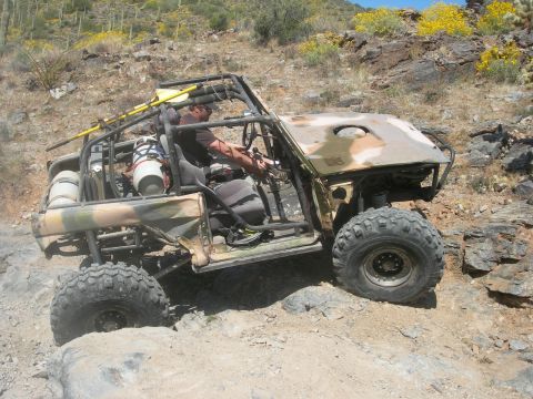 1974 Ford F-250 - A custom-built off-road buggy navigates a challenging rocky trail in a desert environment.