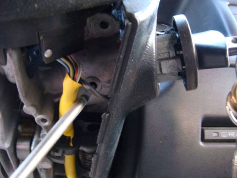 1996 Ford Bronco - Interior view of a vehicle's steering column, showing wiring and ignition components.