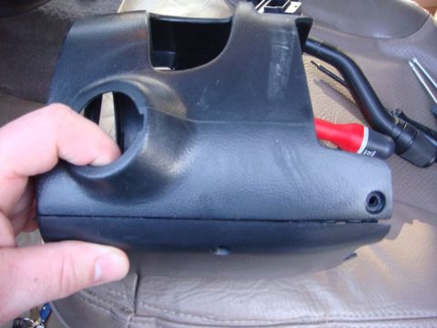 1996 Ford Bronco - Close-up of a black plastic steering column shroud, likely removed for repair or modification.