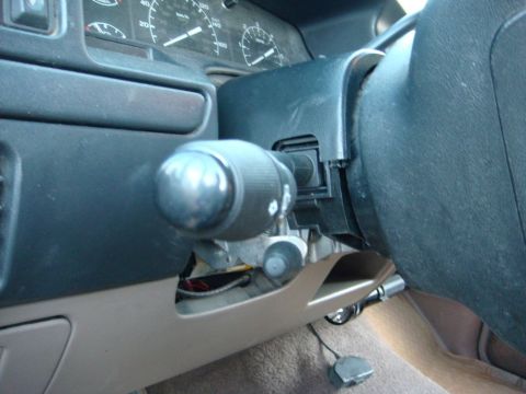 1996 Ford Bronco - Close-up of the interior of a 1996 Ford Bronco, focusing on the steering column and signal switch.