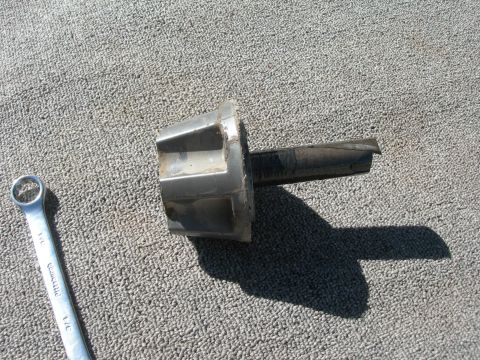 1974 Ford F-250 - A broken stub shaft and a wrench are shown on a carpeted surface. The image has a watermark.