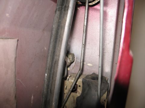 1995 Ford Bronco - Close-up of a car door's internal latching system.