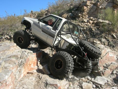 1974 Ford F-250 - Custom rock crawler navigating a difficult rocky terrain.